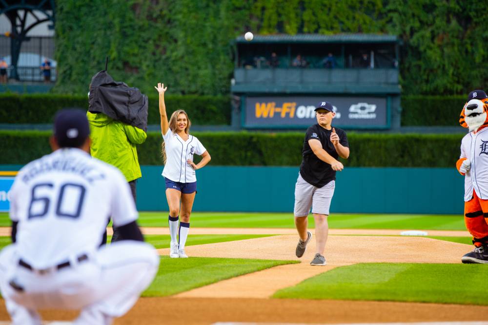 Individual throwing pitch at Comerica Park event